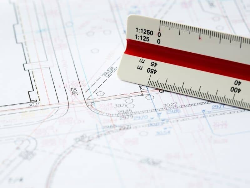 Site plans and measurement scale used to evaluate an aging commercial property before redevelopment