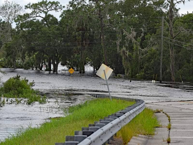 Flooded roadway illustrating the importance of elevation data and floodplain planning when evaluating land for future development.